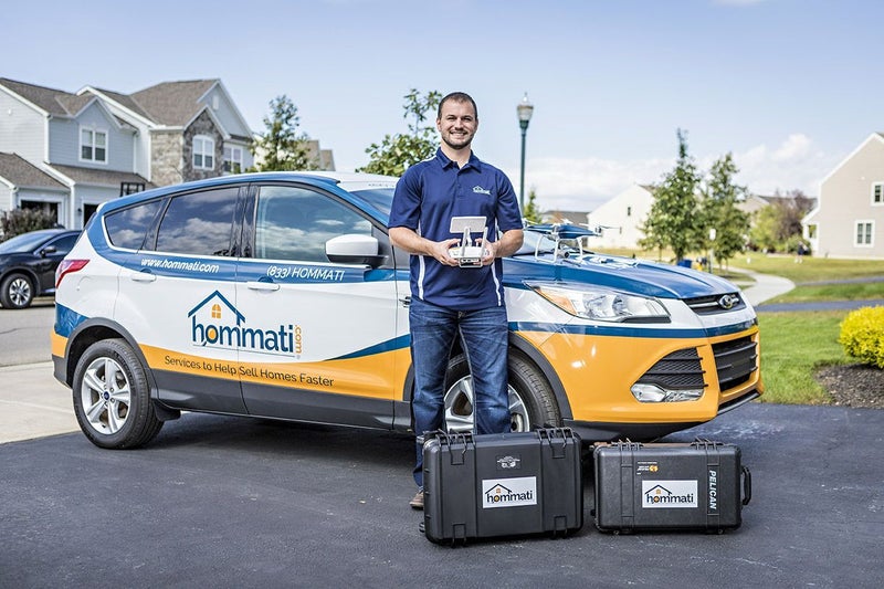 Man standing in front of a car with drone